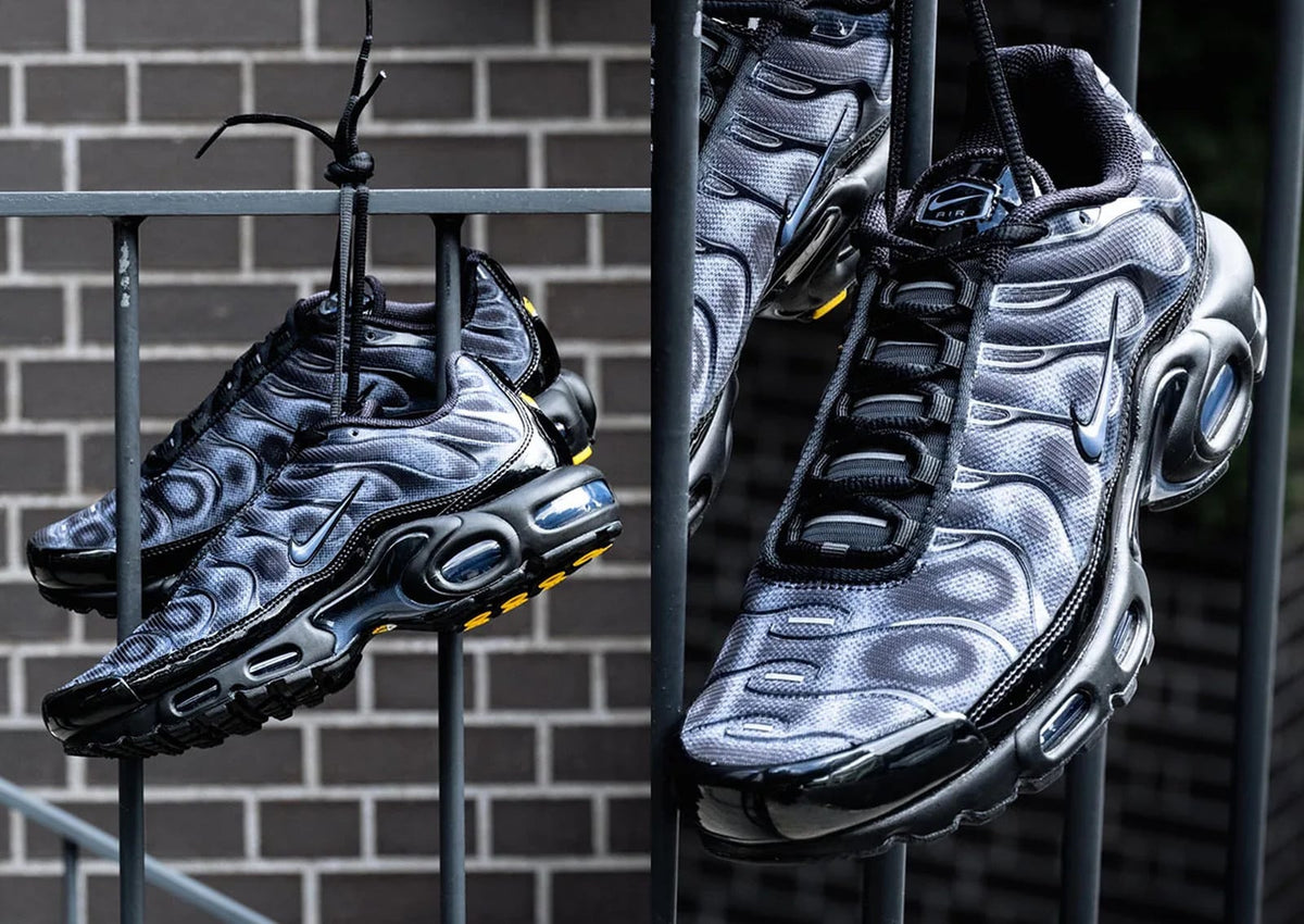 Nike Air Max Plus Black/Cool Grey IQ6605-001 pair hanging from a railing — photo via JustFreshKicks