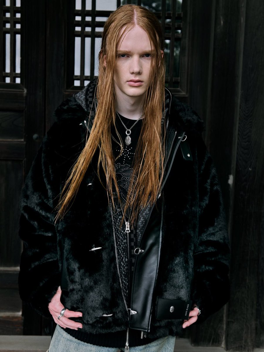 BAPE BLACK FW26 lookbook — model in plush black outerwear against wooden architecture