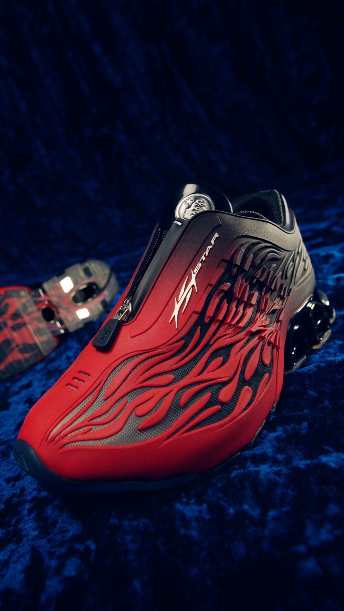 Hellstar x adidas Megaride S2 Bright Red with red-to-black flame upper and zip shroud on blue velvet in the official adidas campaign