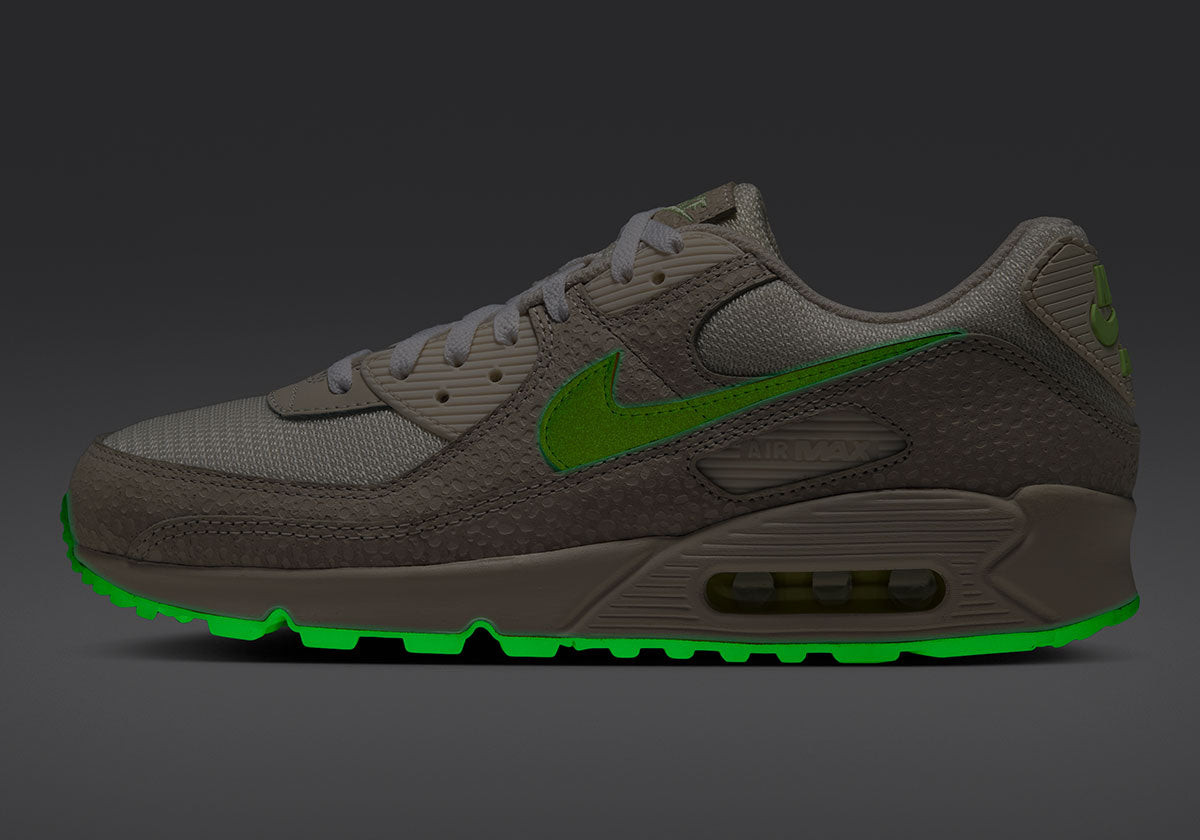 Nike Air Max 90 Glow In The Dark Safari IX5026-030 side view in the dark, with its Barely Volt Swoosh and outsole glowing green. Photo via Sneaker News
