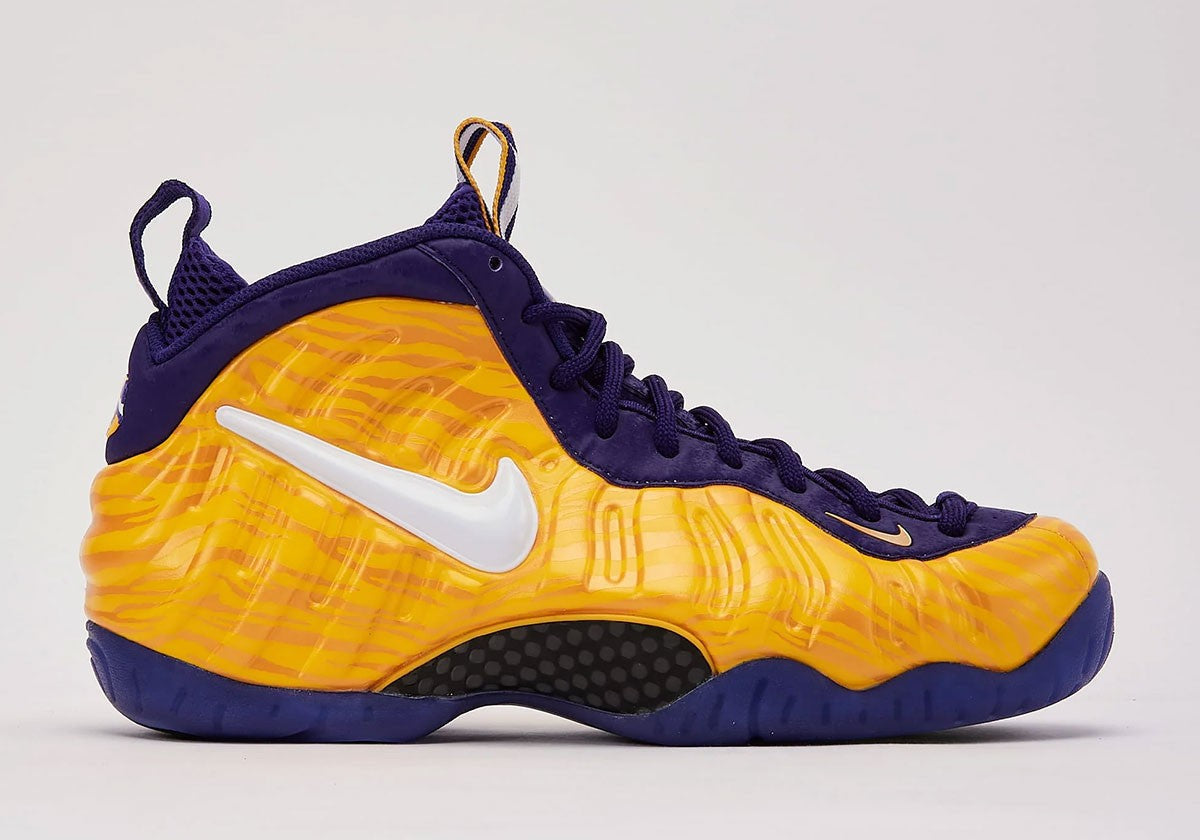Nike Air Foamposite Pro LSU Tigers IX2091-700 in yellow tiger stripe and purple. Photo via Sneaker News