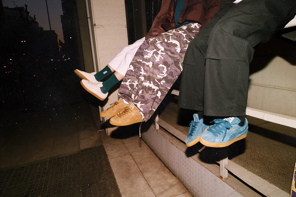 PUMA Suede Forever campaign — three on-model colorways on a night ledge — official Media Hub