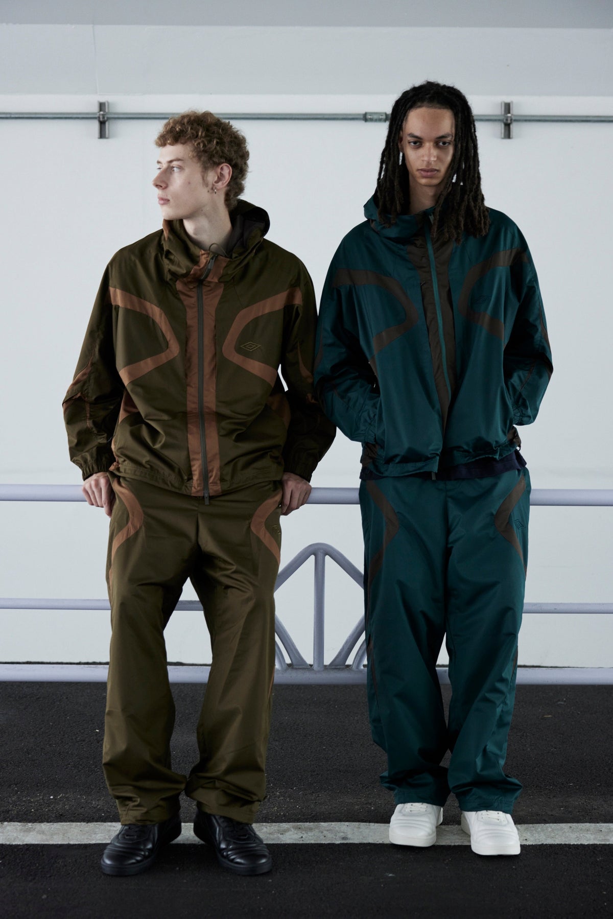 Umbro × White Mountaineering FW26 hooded jackets and easy pants on two models outdoors — official White Mountaineering lookbook