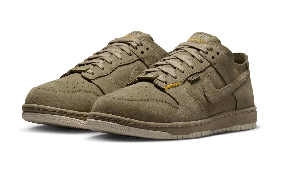 Pair of Union LA x Nike Dunk Low SP "Bamboo" IF7380-200 sneakers in tonal bamboo suede with yellow stitching. Official Nike image via House of Heat