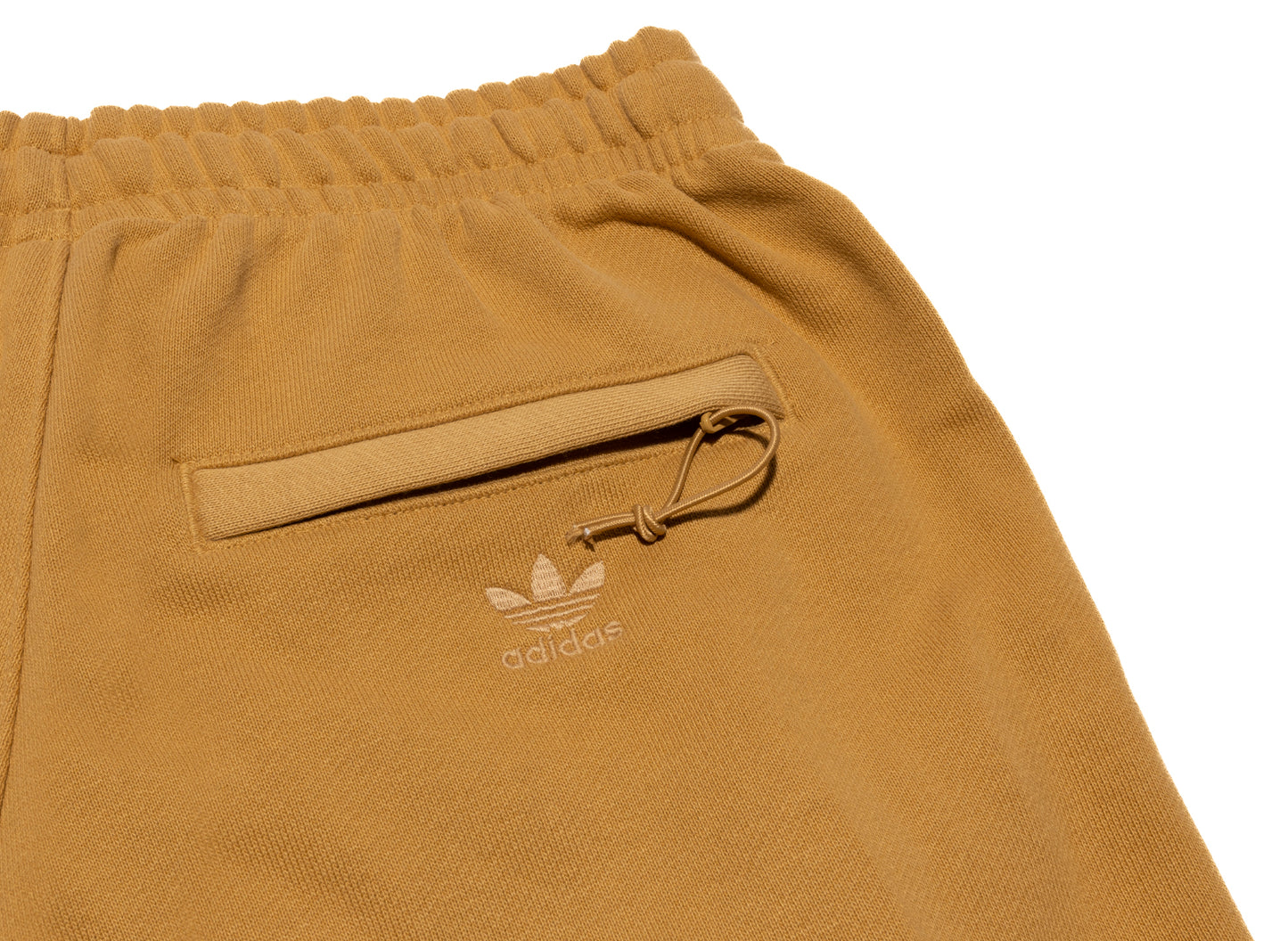 Pantalones cortos Adidas Pharrell Williams Basics en dorado