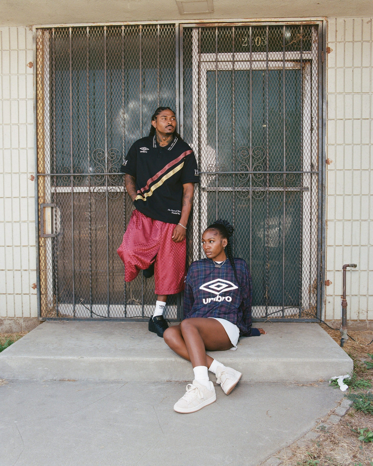 WSS Athletics × Umbro × Steven Mena lookbook — models in Umbro polos and shorts outside LA storefront