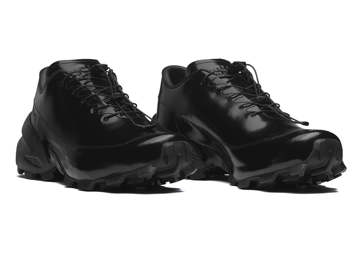 MM6 Maison Margiela x Salomon Crossderby in glossy black leather with drawstring lacing and trail sole, FW26 Drop 1 (Oct 22). Photo via Sneaker News