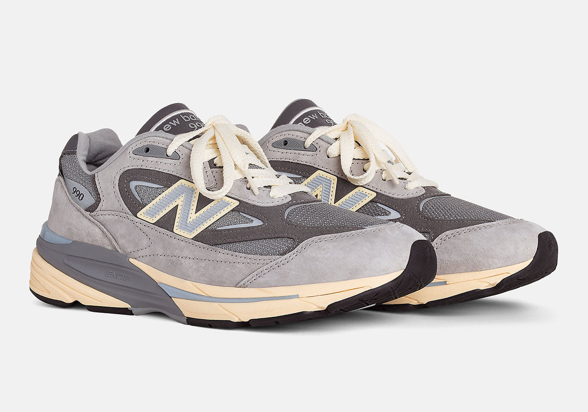 New Balance 990v7 Made in USA Kool Grey U990GR7 pair in grey suede with pale blue and yellow N. Photo via Sneaker News