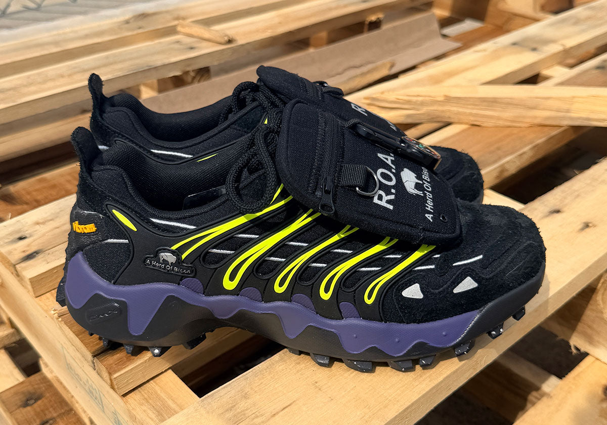 A Herd of Bison x Reebok Trailzillo DMX pair in black with lime green and purple. Photo via Sneaker News