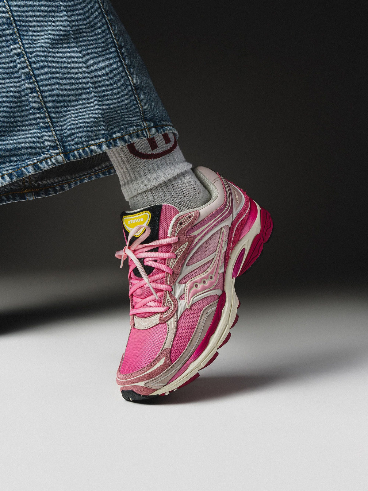 On-foot atmos x Saucony ProGrid Omni 9 Pink Flamingo — pink mesh runner with cream midsole and magenta outsole. Photo via House of Heat