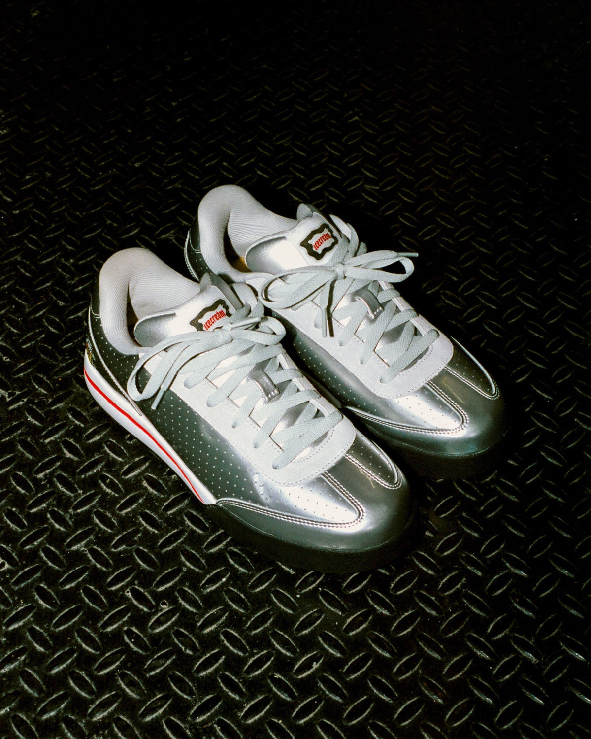 Ice Cream × Reebok Board Flip Silver on diamond-plate floor — official BBC Ice Cream lifestyle