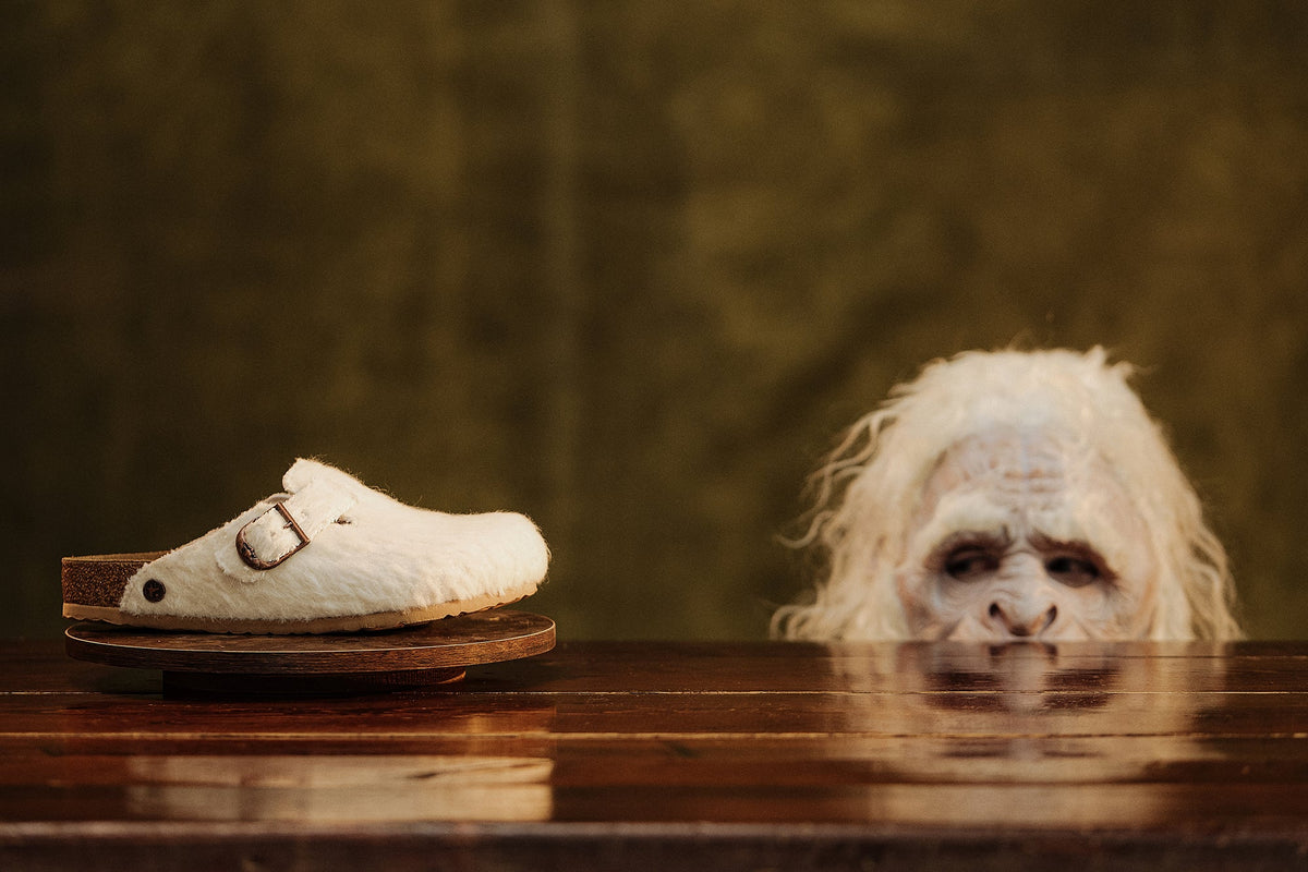 Birkenstock by Cole Bennett furry Boston clog on pedestal with yeti character — official Birkenstock 1774 campaign