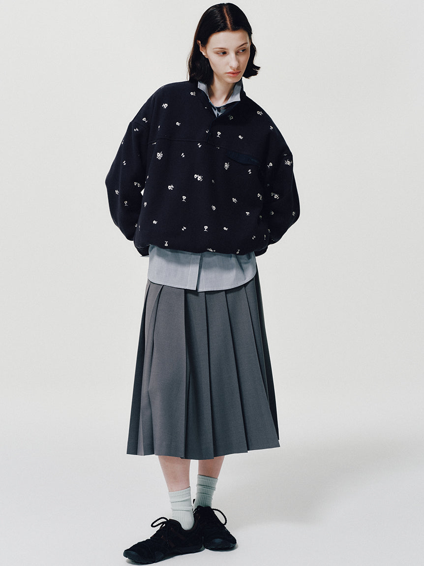 On-model New Balance for emmi MT10O6WL Black lookbook: model in black embroidered fleece, layered shirt, charcoal pleated skirt and black MT10 sneakers
