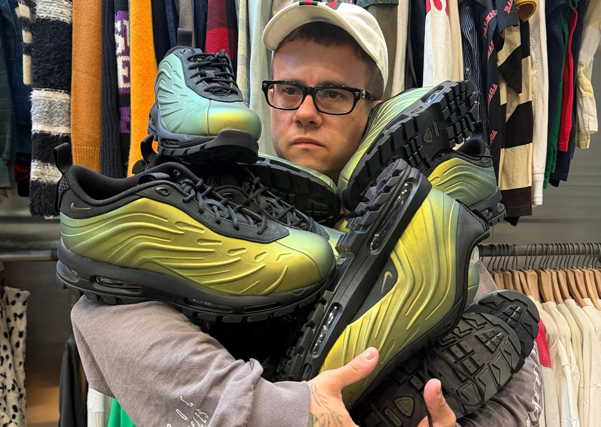 Luke's NYC owner Luke Fracher holding an armful of Nike Air Max Foamdome Low Green Goblin pairs in his store. Photo via Luke's NYC / Sole Retriever