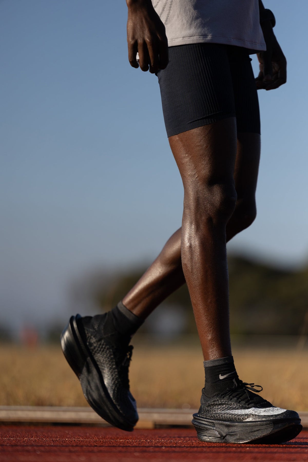 Jacob Kiplimo mid-stride on a red track in Nike Apex marathon racing shoes — official Nike newsroom