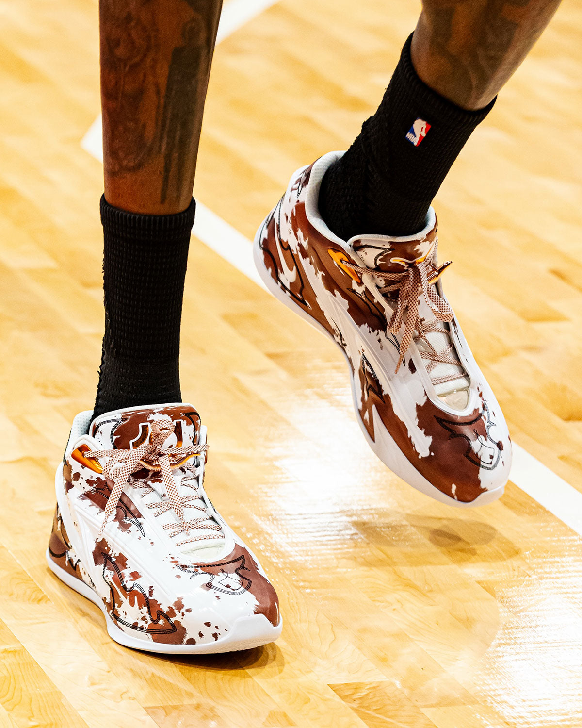 Kevin Durant wearing the Nike KD 19 Texas JJ5279-100 in brown cow print on court. Photo via Sneaker News