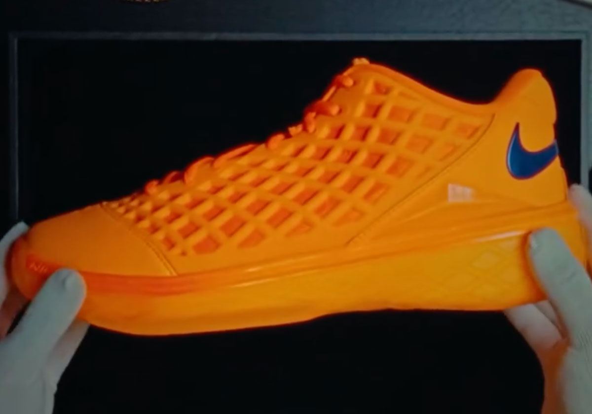 Jalen Brunson's Nike Kobe 3 Low Protro PE in tonal orange with a blue Swoosh, lateral side. Image via Sneaker News
