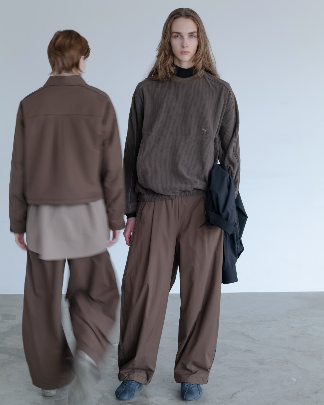 PROJECT PUMA PLUS 2026 AW look: models in earth-tone ribbed crewneck and technical trousers