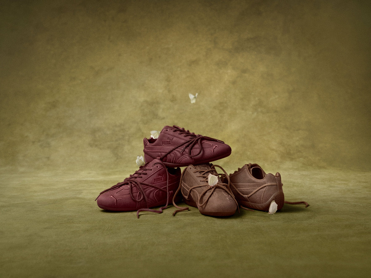PUMA x ROSÉ Speedcat VTG in Burgundy and Espresso stacked on an olive backdrop with falling petals — official PUMA campaign image