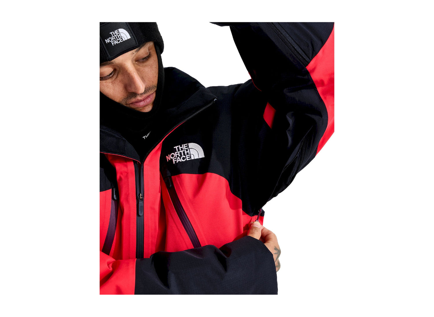 The North Face Snowsquall Jacket in Elevation Red / TNF Black, underarm detail worn by a model