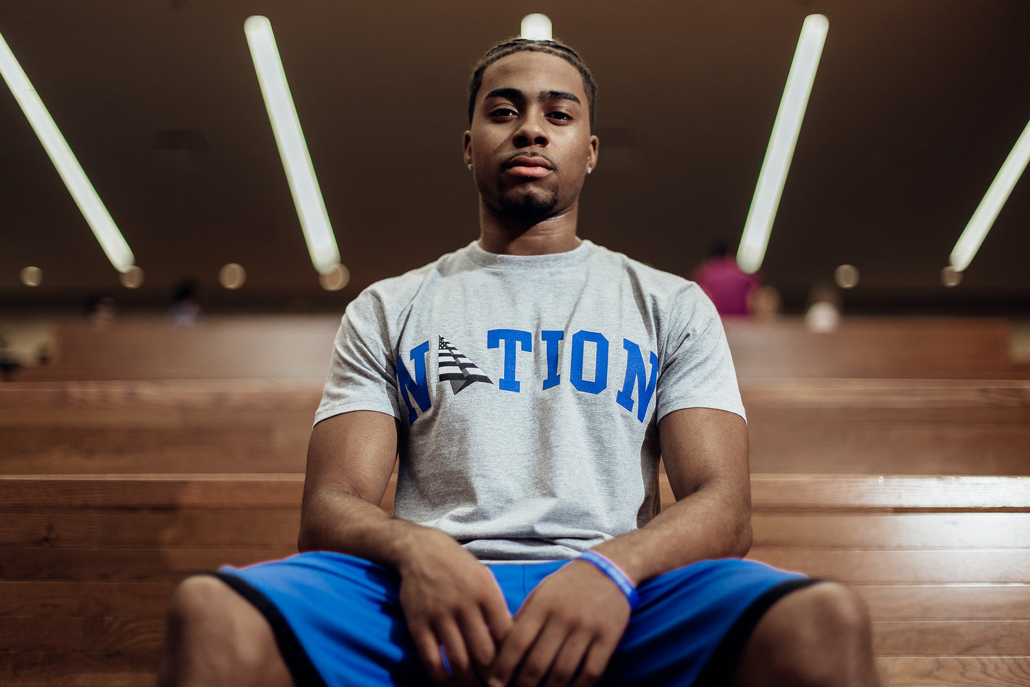 Roc Nation x Oneness Nation Tee, worn by a seated model